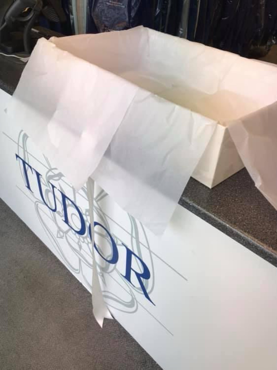 A wedding gown preservation box lined with tissue paper, branded Tudor