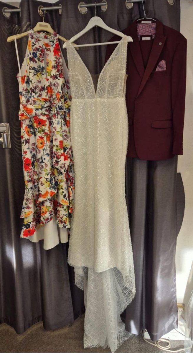 A floral dress, white lace dress and burgundy suit cleaned and pressed on hangers